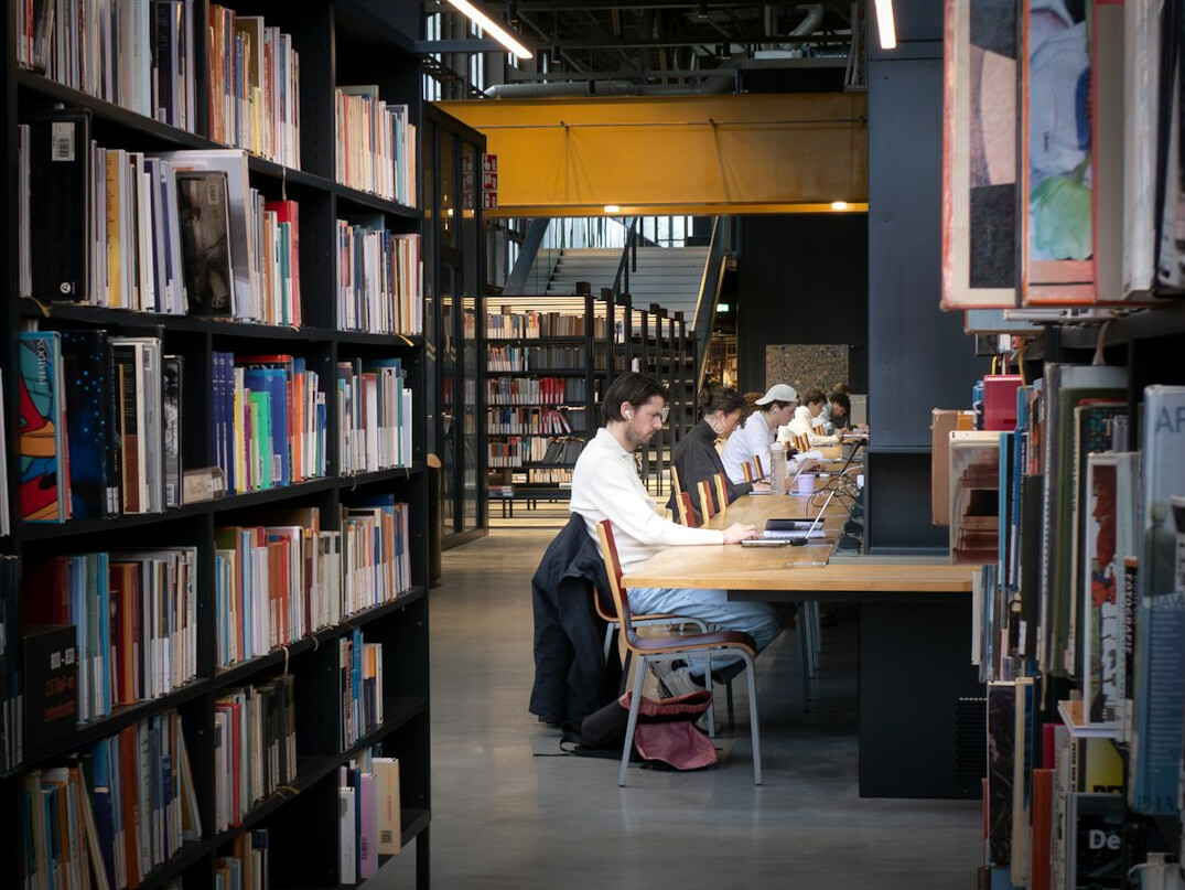 person reading book at desk