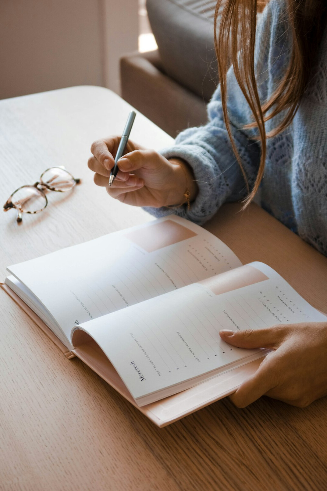 person writing in planner