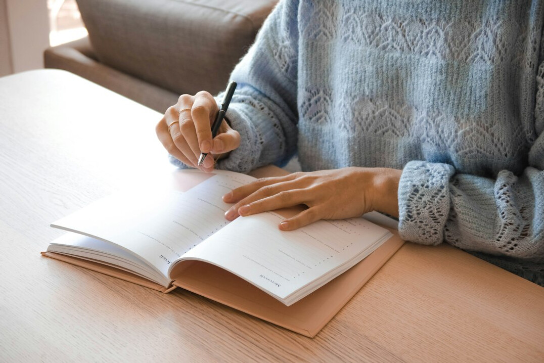 person writing in planner