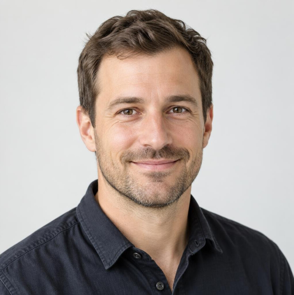 Portrait of a man with short dark hair in a casual shirt